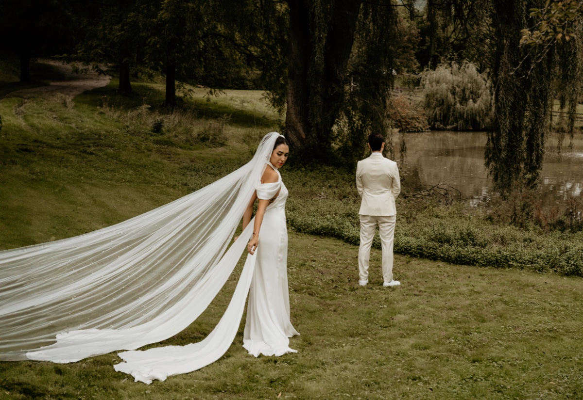 outdoor first look with cathedral veil