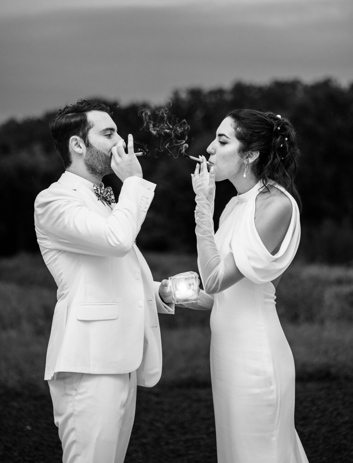 bride and groom smoking at wedding