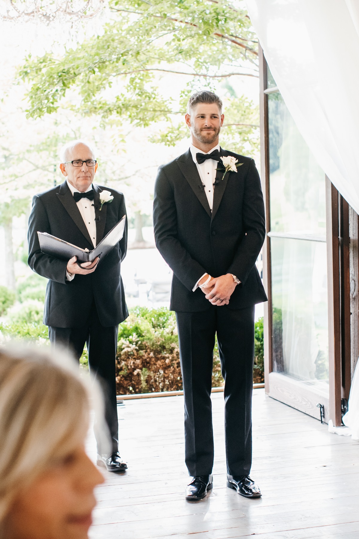 Austin Watson at his wedding ceremony in tuxedo