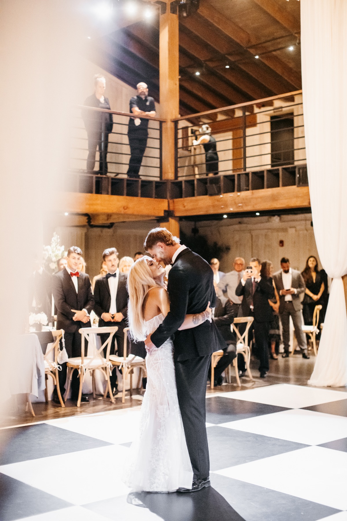 Austin Watson and wife first dance on checkerboard dance floor
