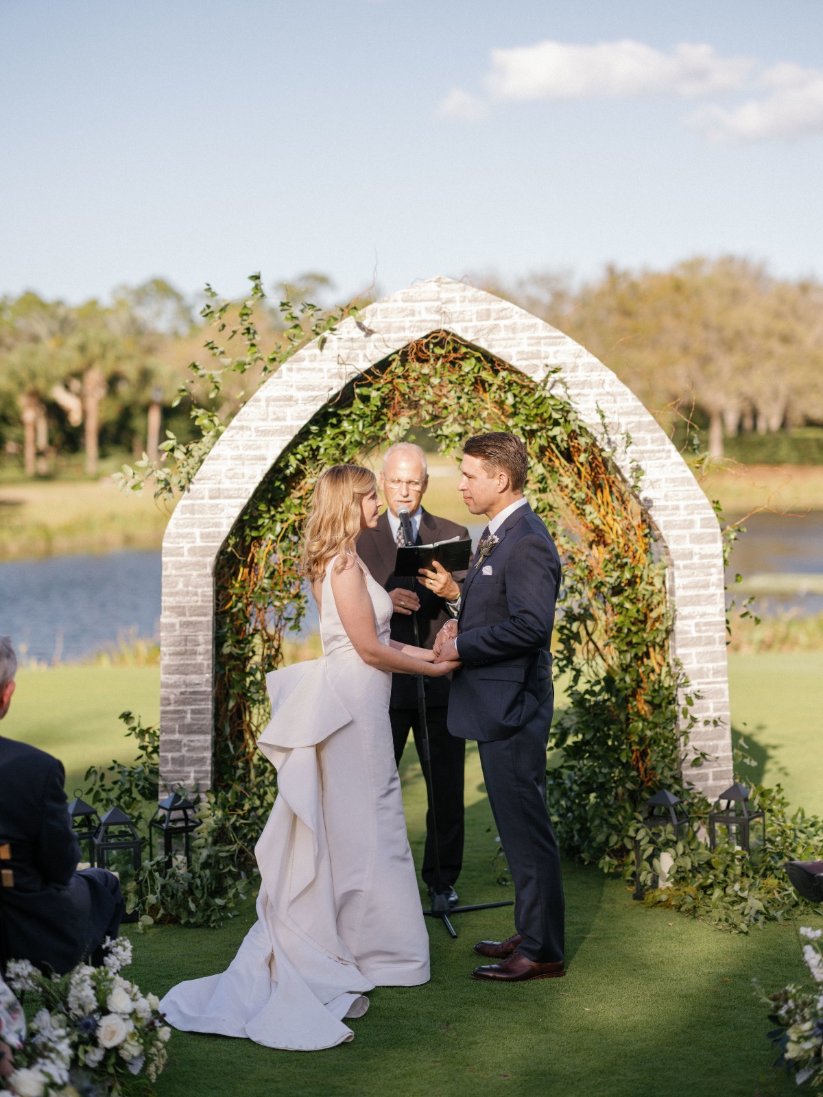 romantic wedding ceremony with stone arch