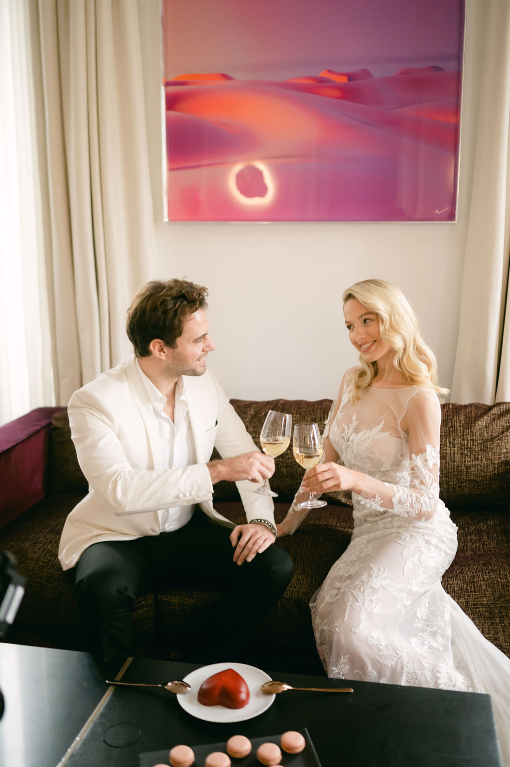 Bride and groom toasting in Paris hotel room 