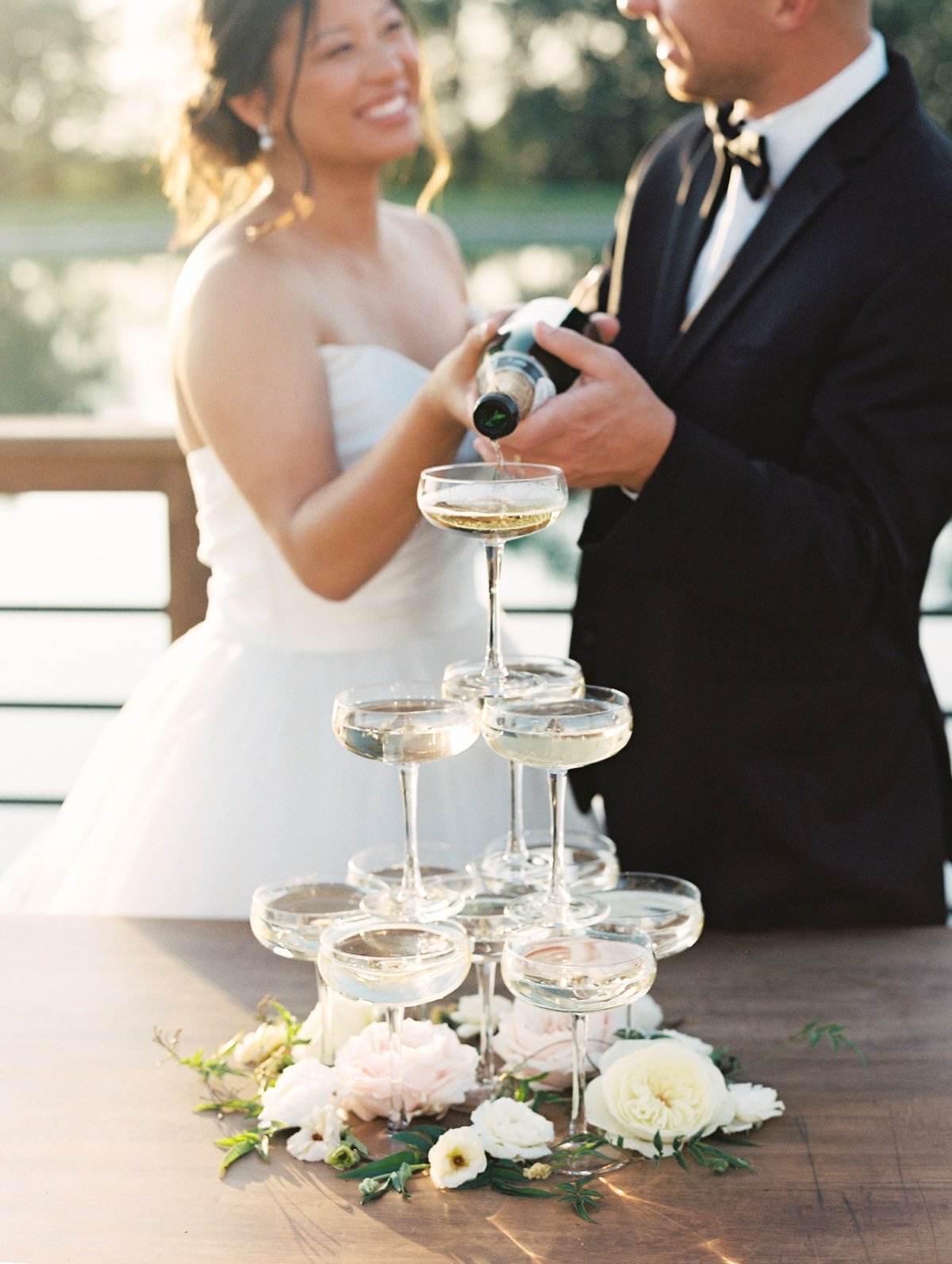 bride and group pouring a champagne tower