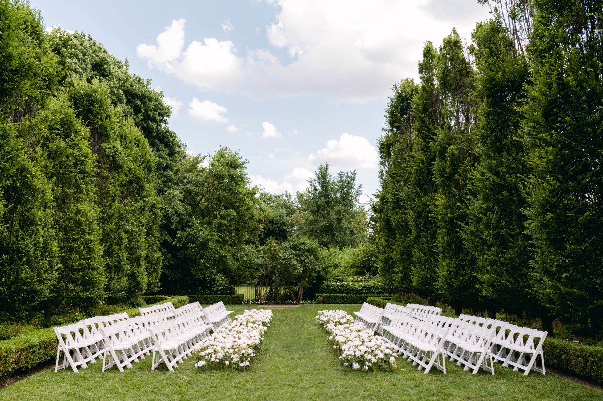 Runway style wedding ceremony in lush garden venue