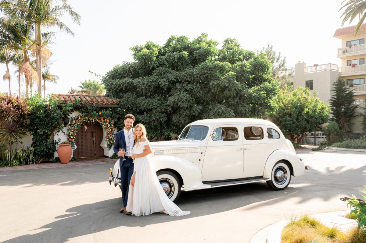 Bride and groom with vintage car 
