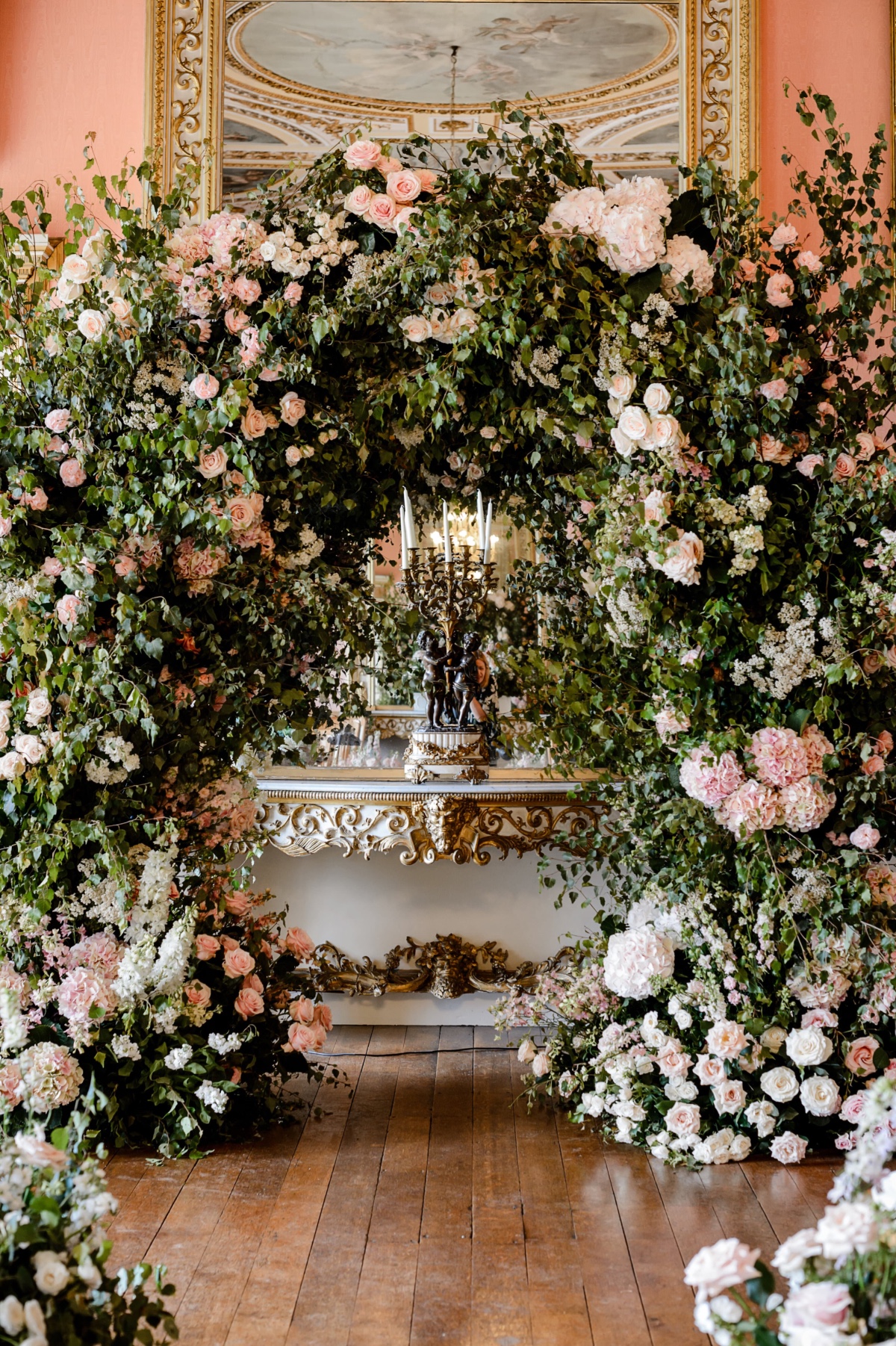 large dusty rose and greenery arch