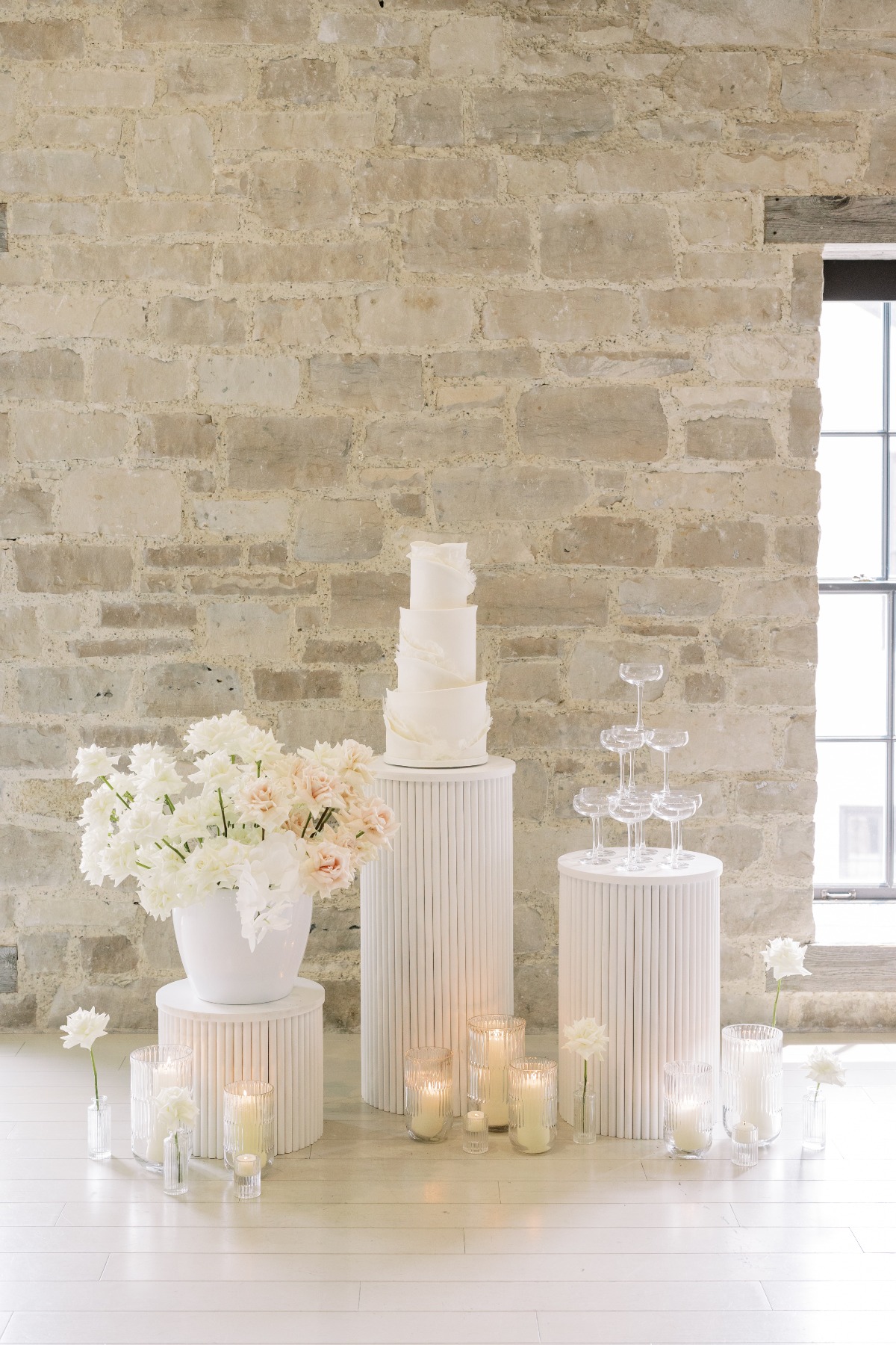 Elegant modern wedding cake table on tall cylindrical stands