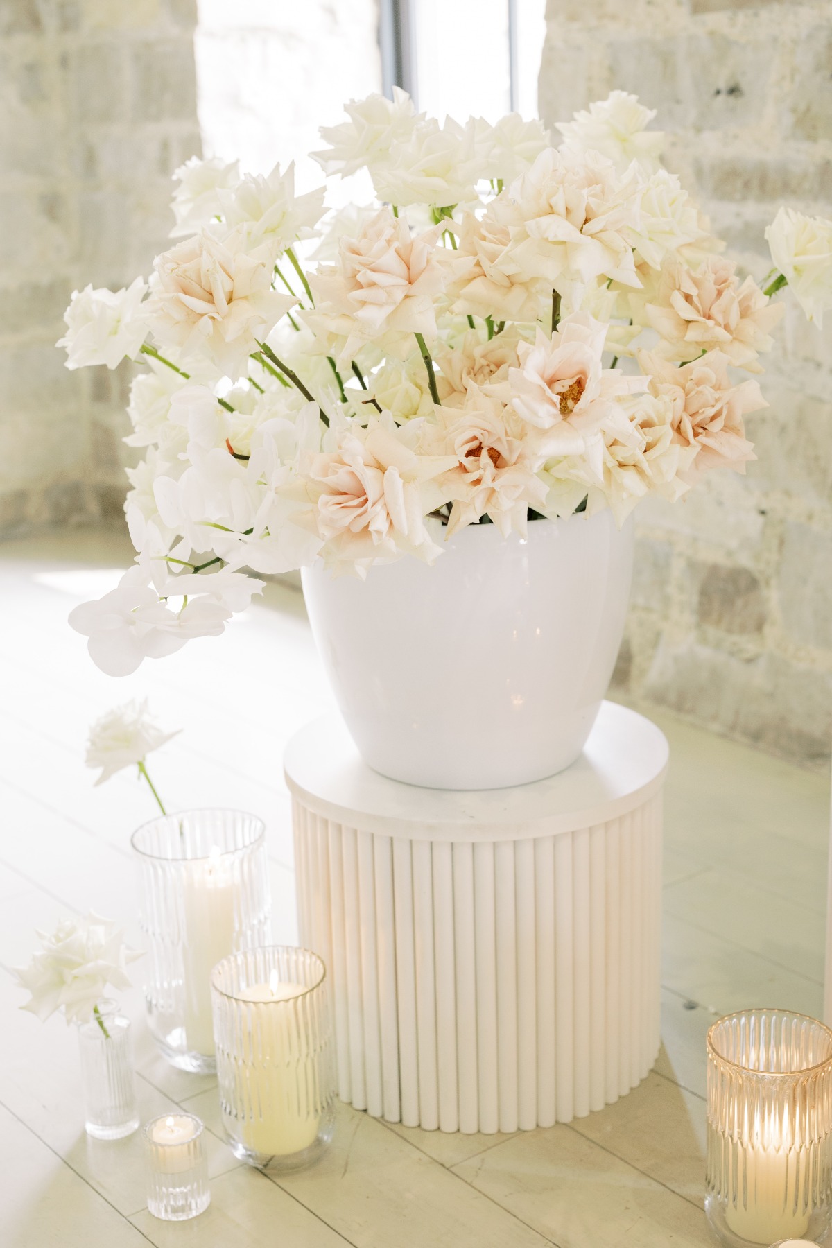 Lush white floral bouquet for wedding cake table 