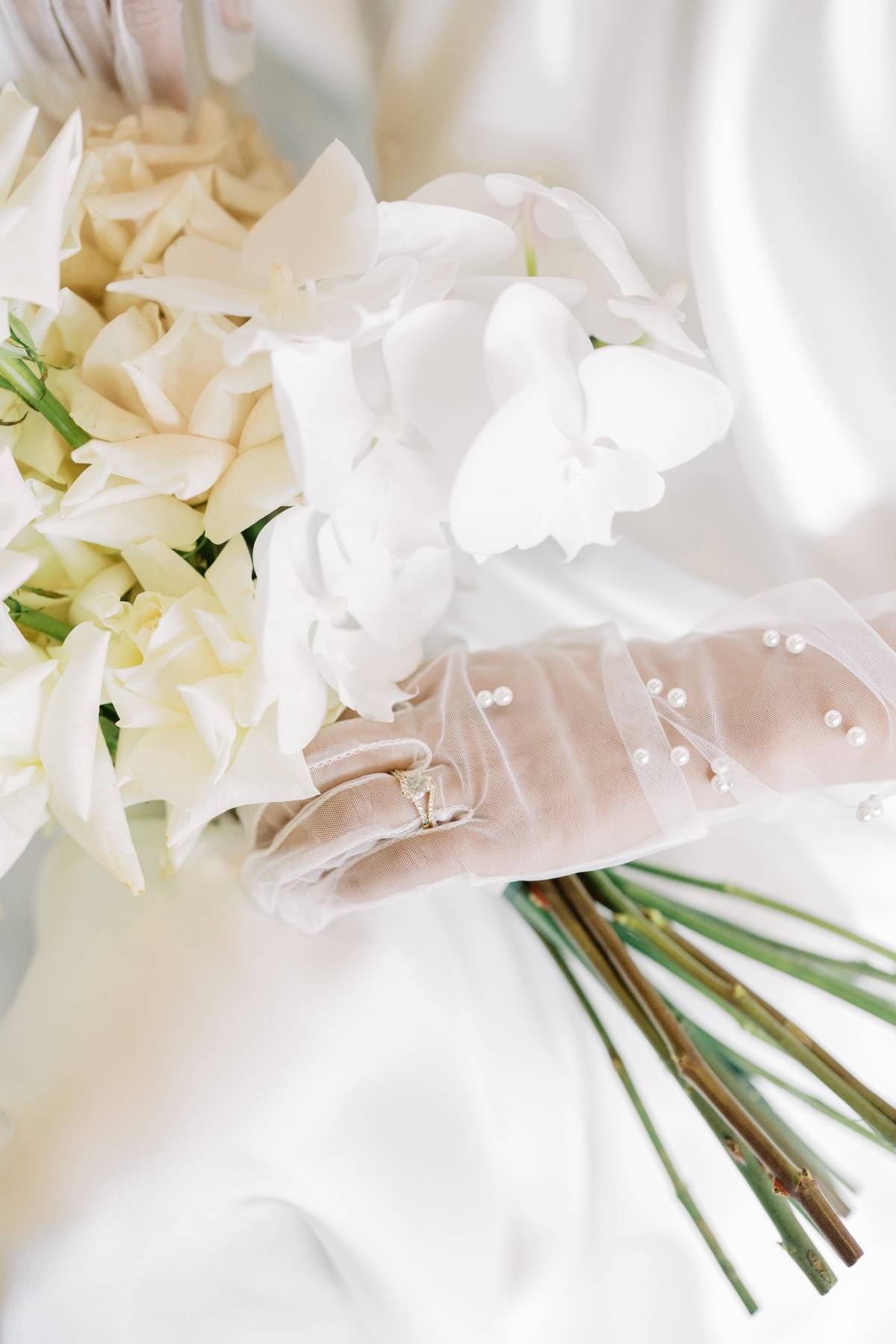 Pearl bride gloves with white orchid wedding bouquet 