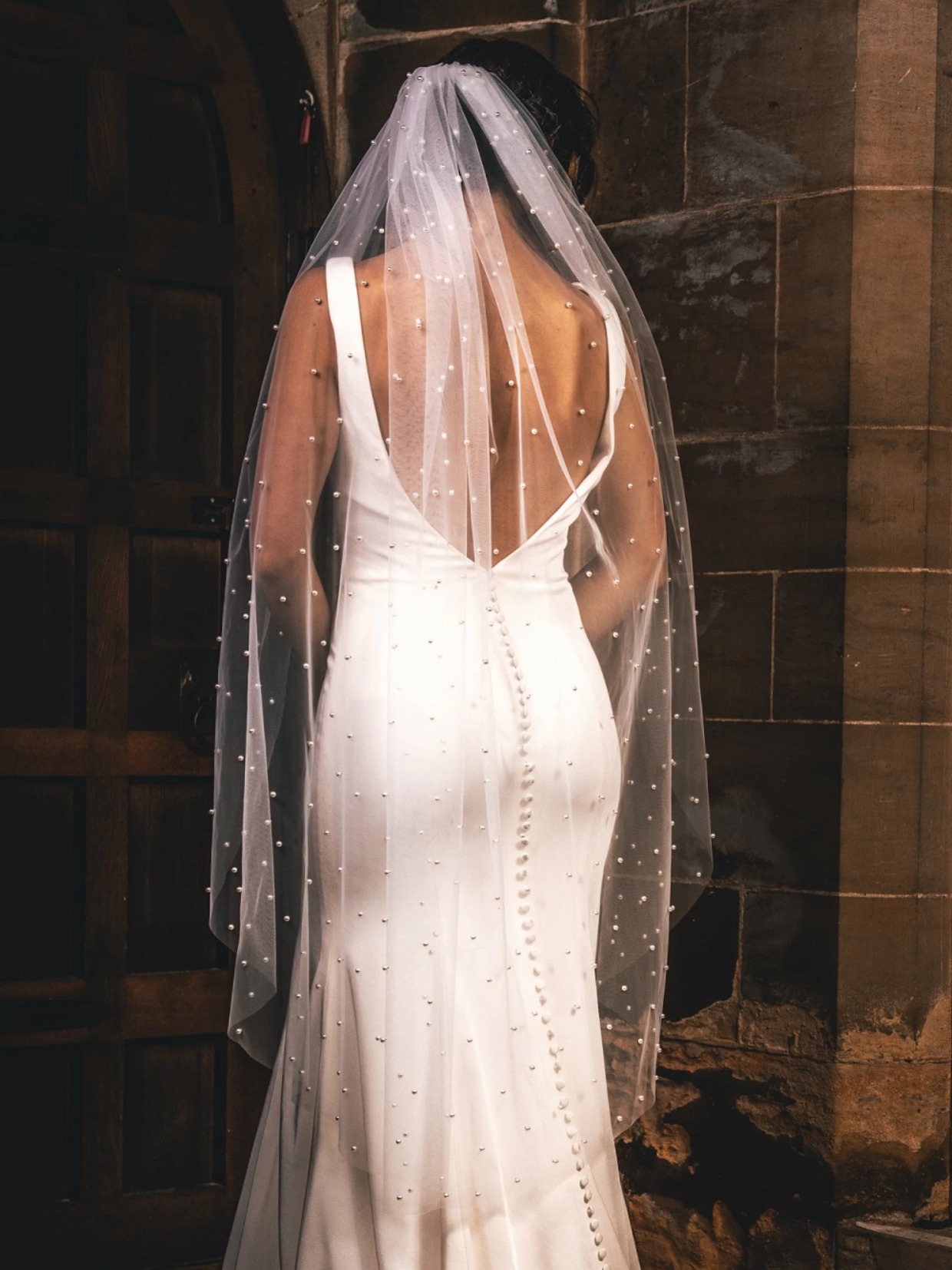 https://www.weddingchicks.com/wp-content/uploads/2023/11/perfect-bridal-ivory-single-tier-cut-edge-scattered-pearl-veil-8686.webp