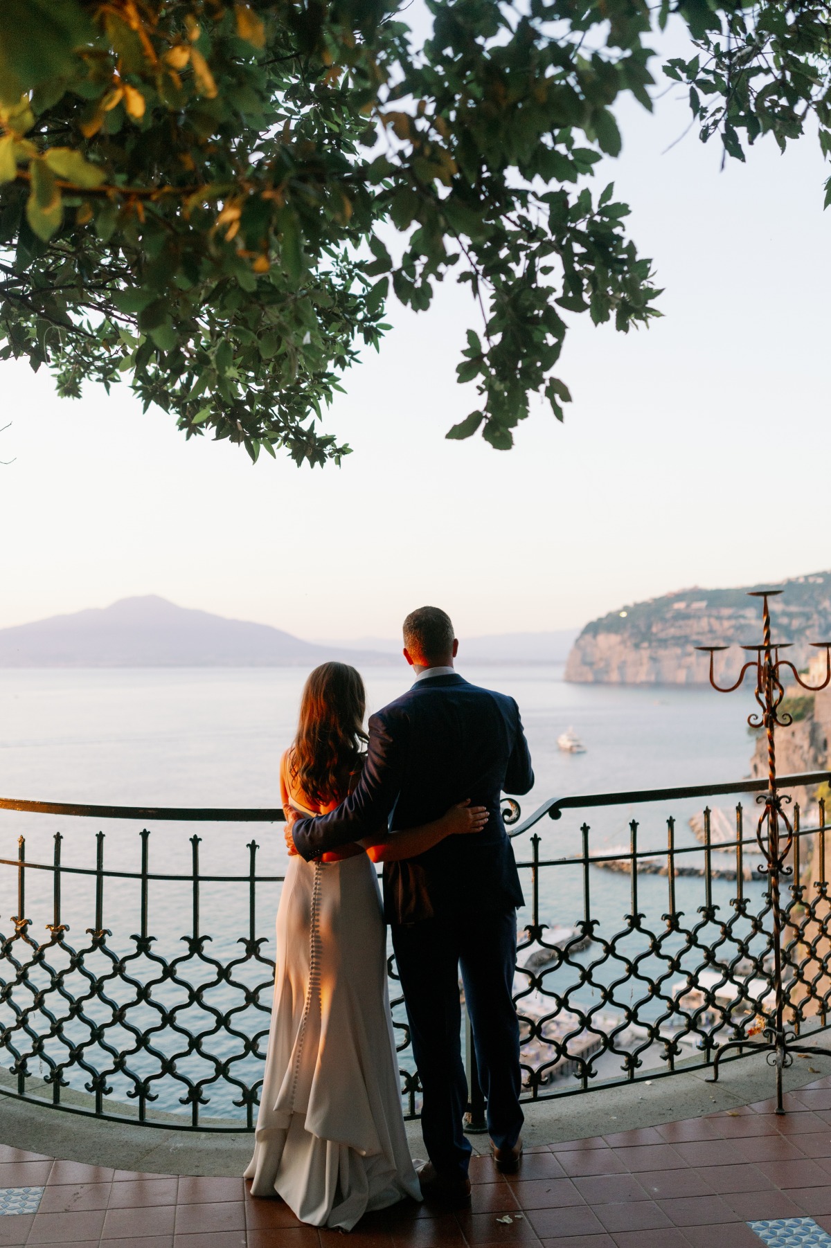 Bride and groom watching sunset in Italy