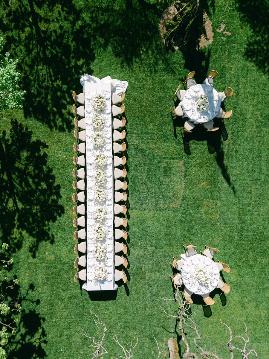 Aerial view of elegant white reception tables for outdoor wedding