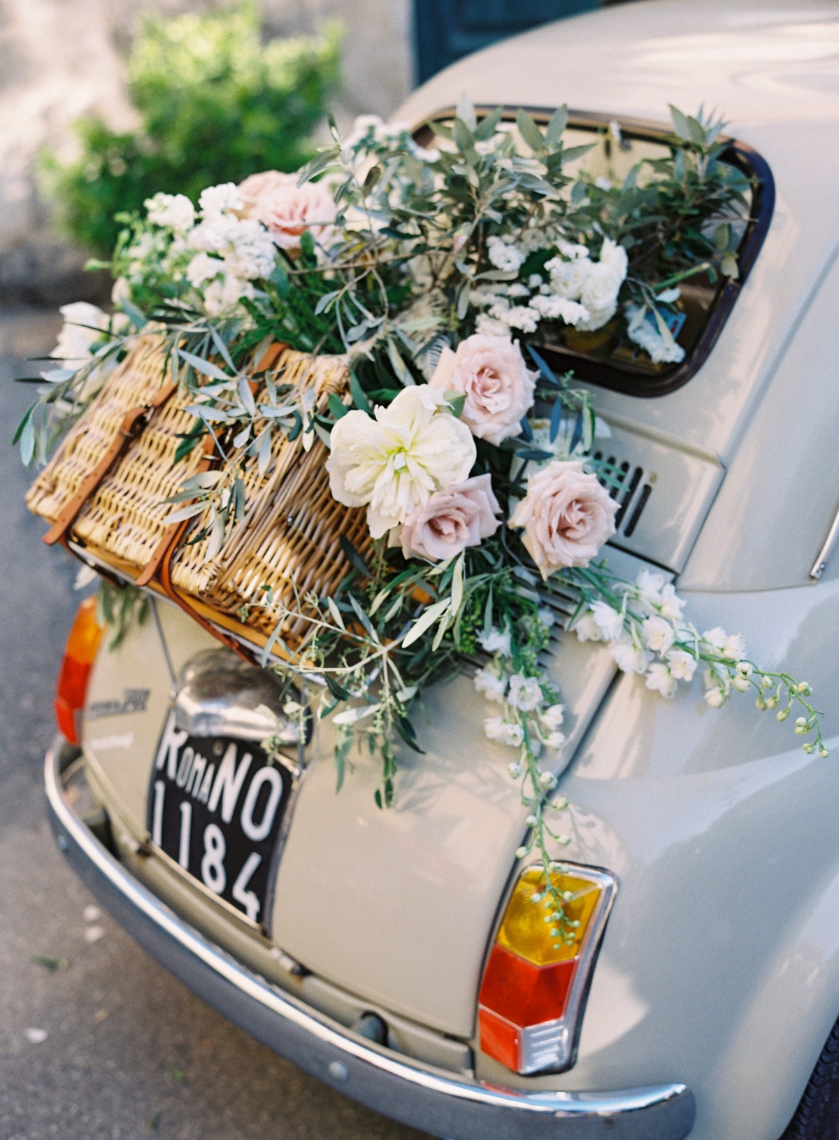 Flower covered vintage Fiat rental in Tuscany region of Italy