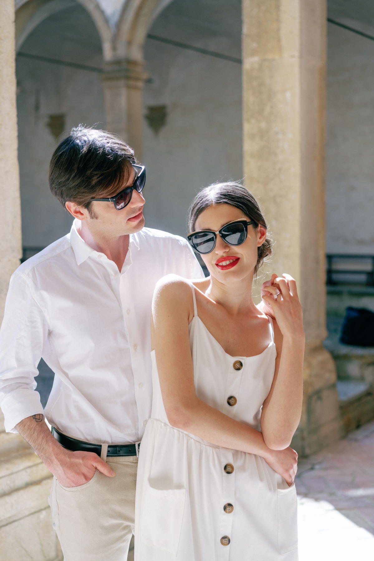 Chic bride and groom in white linen honeymoon outfits