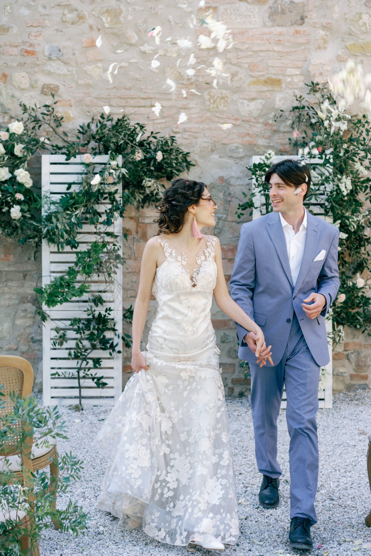 Newlyweds at rustic Italian outdoor wedding ceremony 