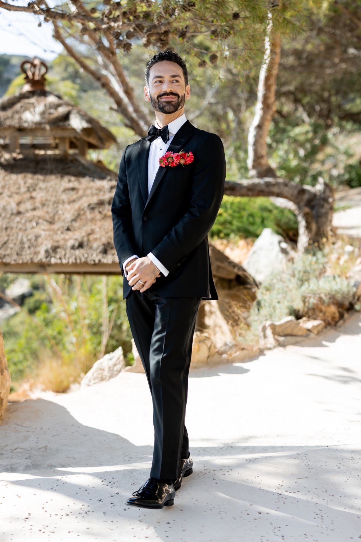 Fashionable LGBTQ groom in tailored tuxedo in Ibiza 