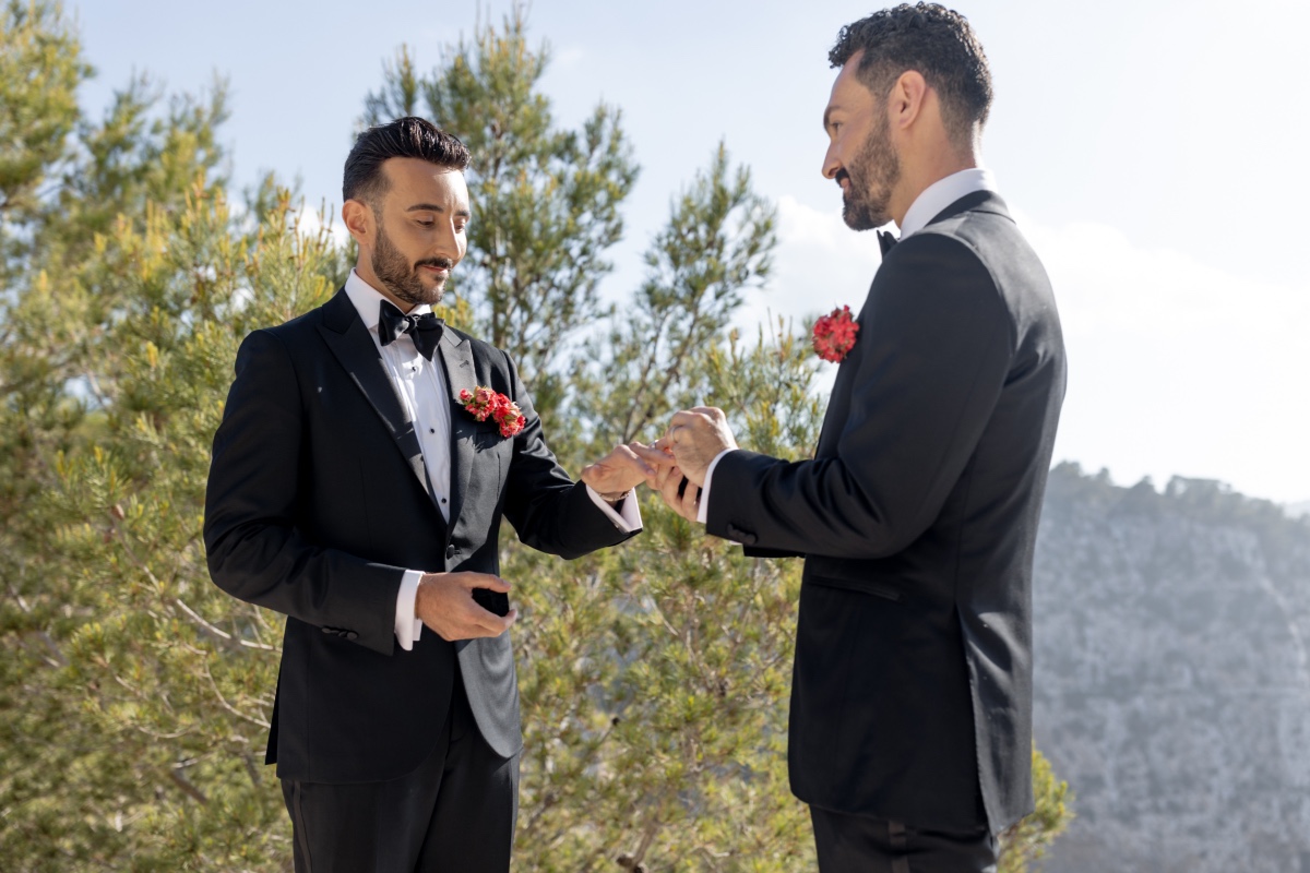 Grooms exchanging rings at outdoor Ibiza wedding ceremony 