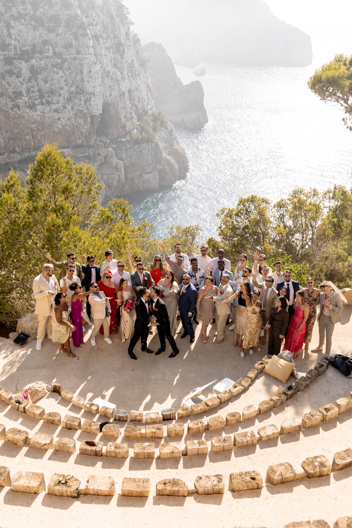 Two grooms kiss at destination cliffside wedding in Ibiza