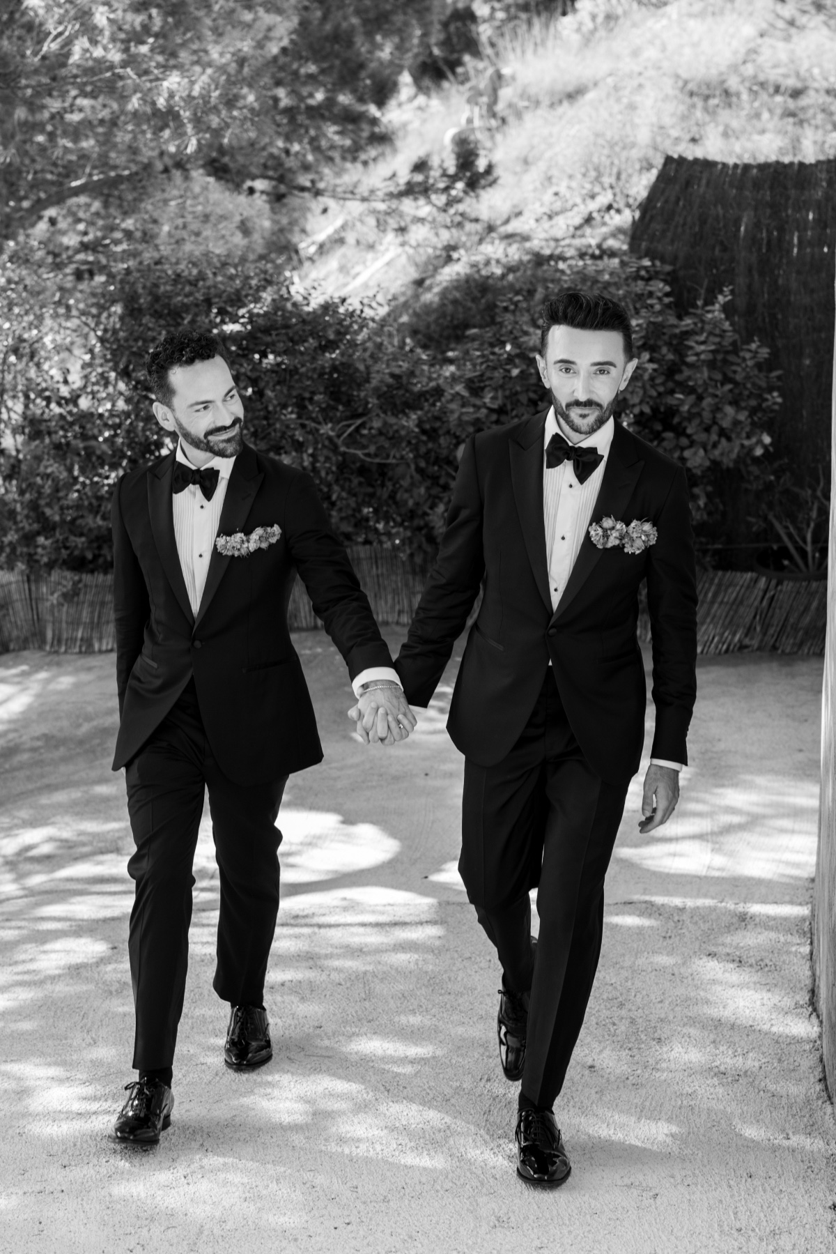 Handsome two grooms in stylish suits and loafers 