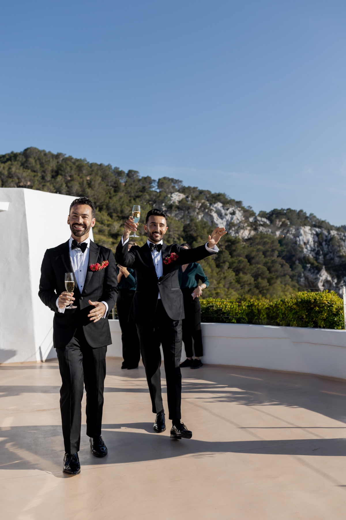 Grooms entering modern wedding reception in Ibiza Spain