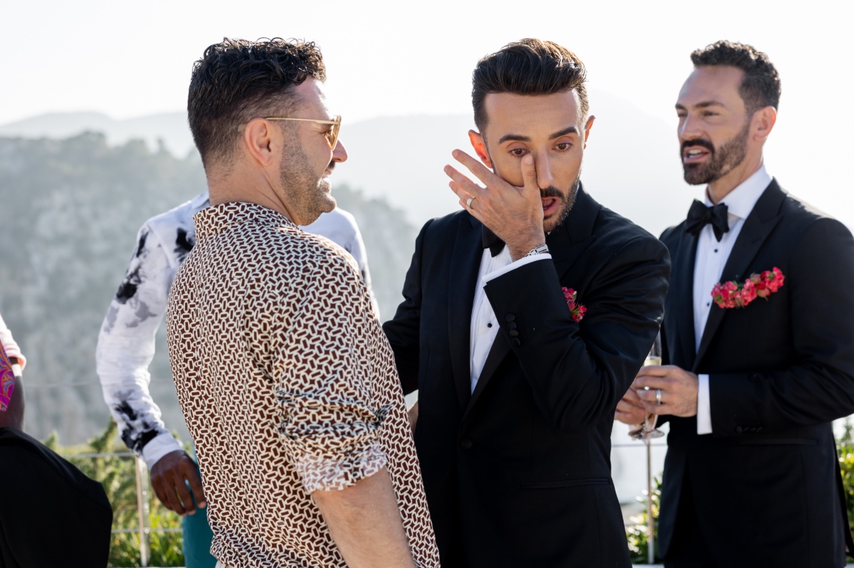 Grooms crying with guests after the wedding ceremony 