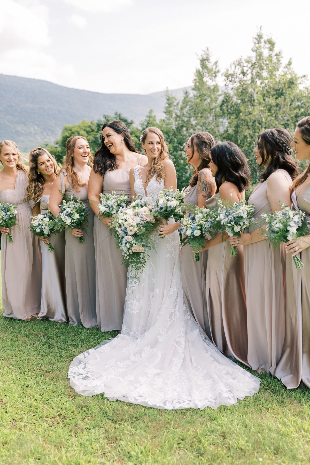 Elegant bride and bridesmaids carrying blue floral bouquets
