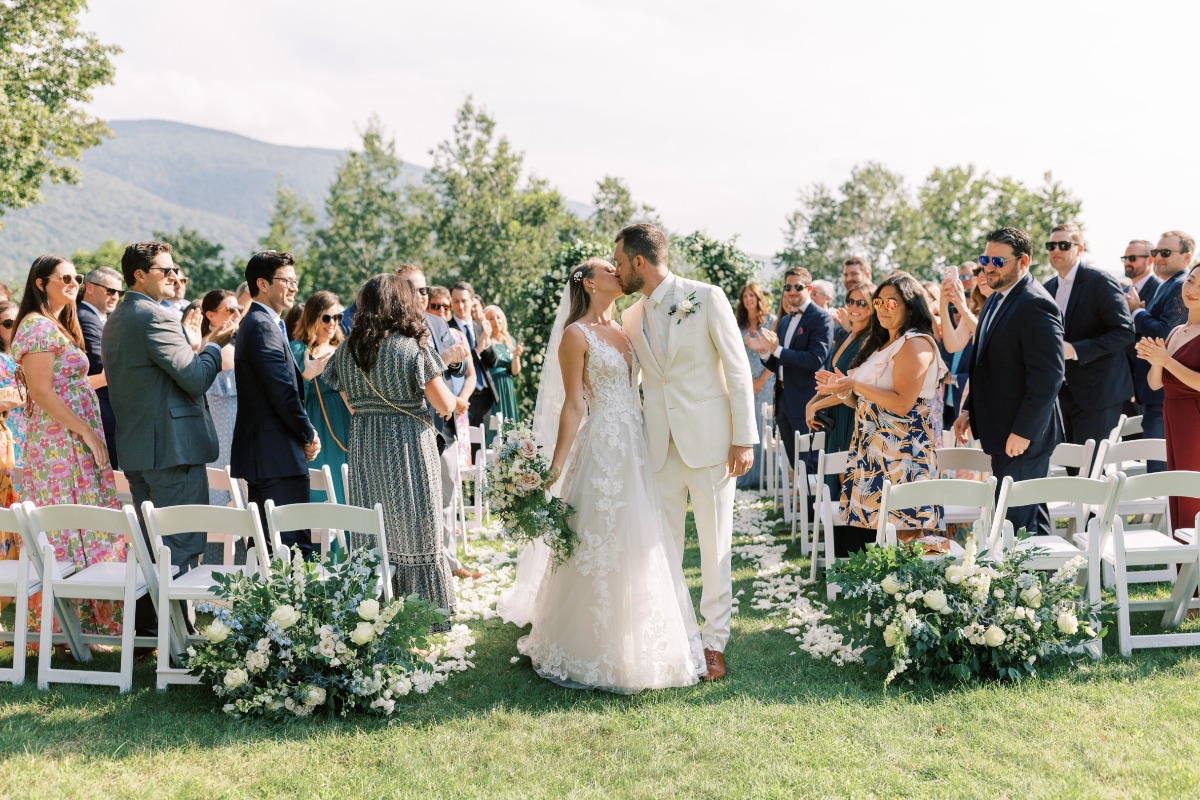 Newlyweds kiss at gorgeous outdoor wedding ceremony in Vermont