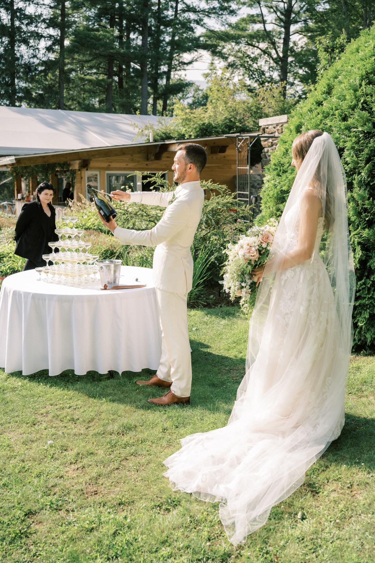 Post-ceremony outdoor wedding toast with champagne tower 