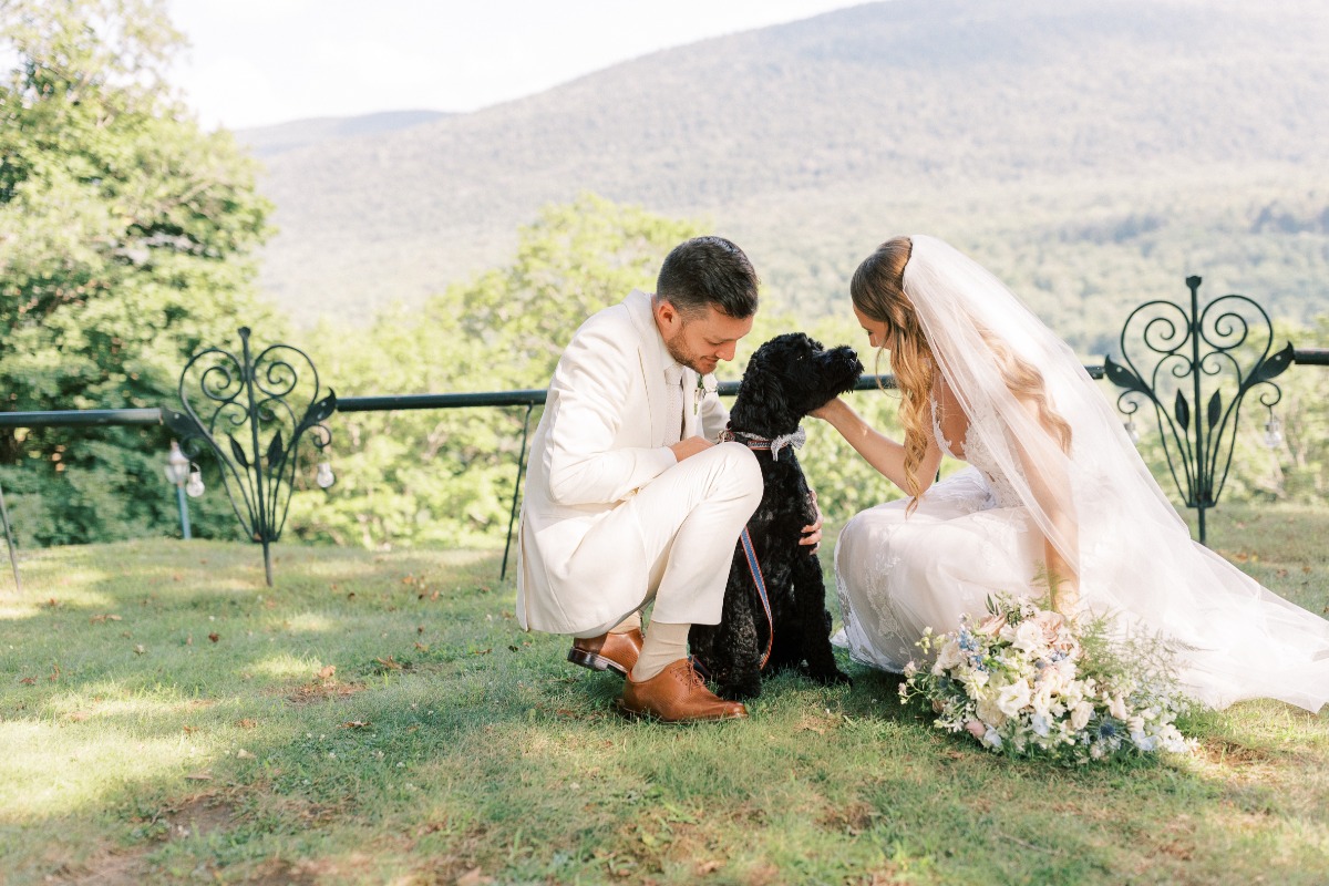 Vermont bride and groom playing with adorable dog ring bearer