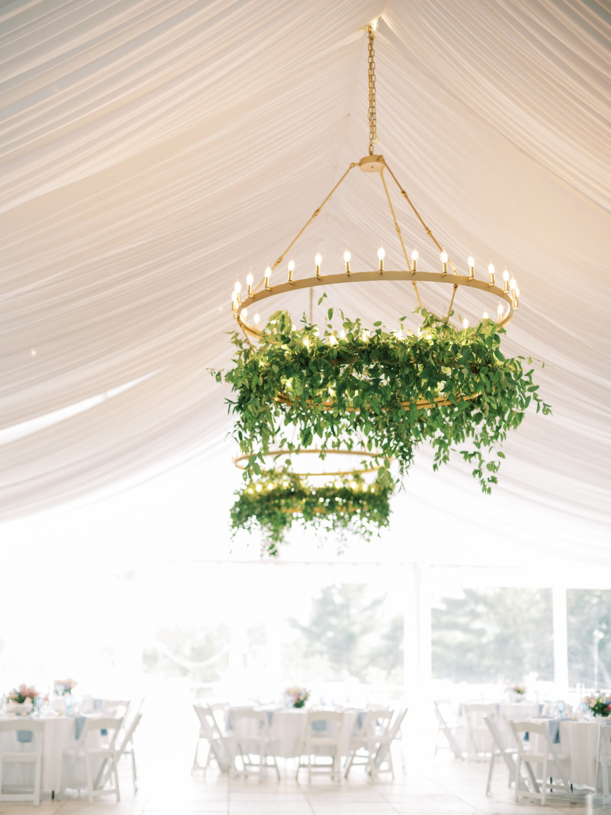 Lush hanging greenery for tented reception chandelier 