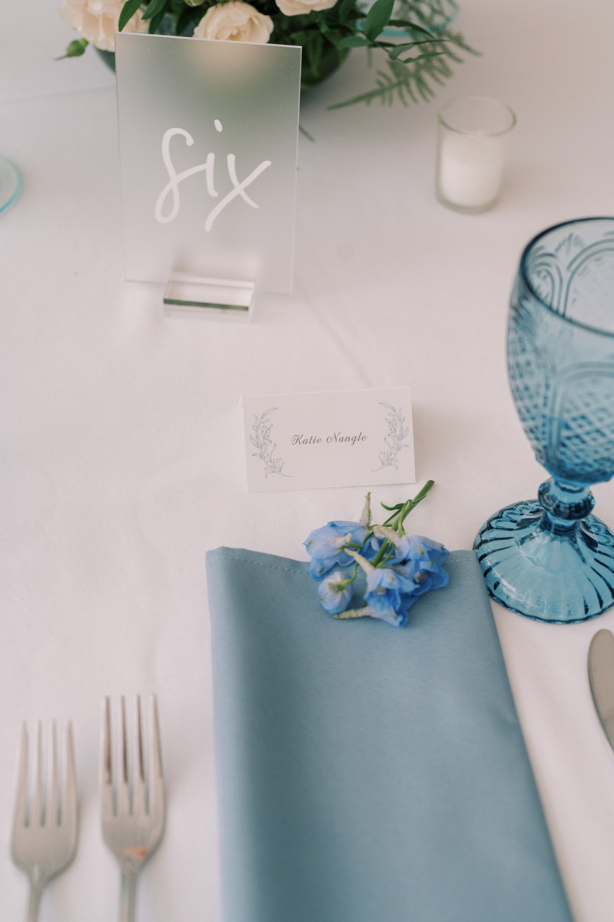 Dusty light blue wedding reception decor and glassware 