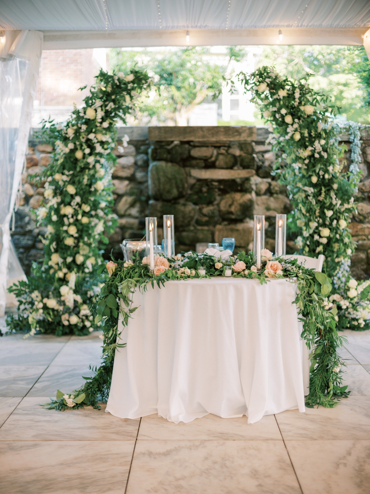 Elegant draping greenery covered sweetheart table for reception