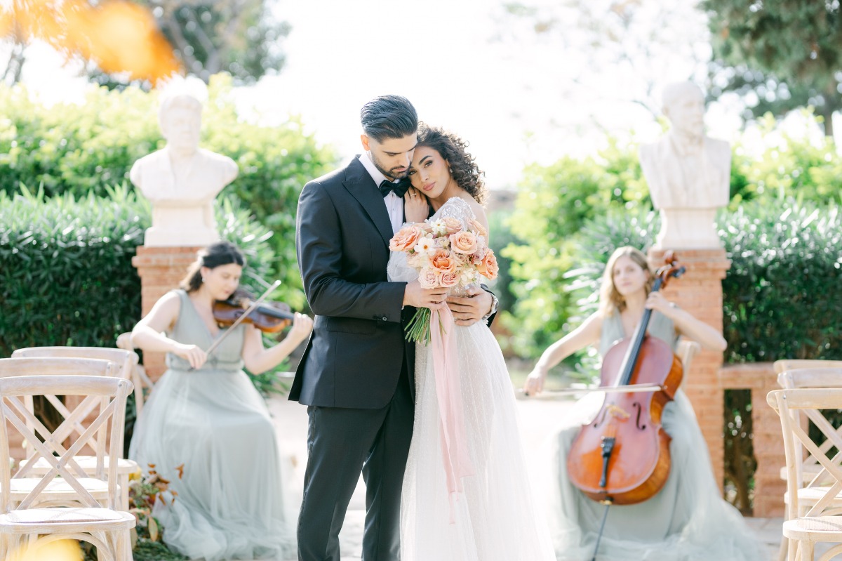 Newlyweds cuddle to string duo at destination Greek wedding