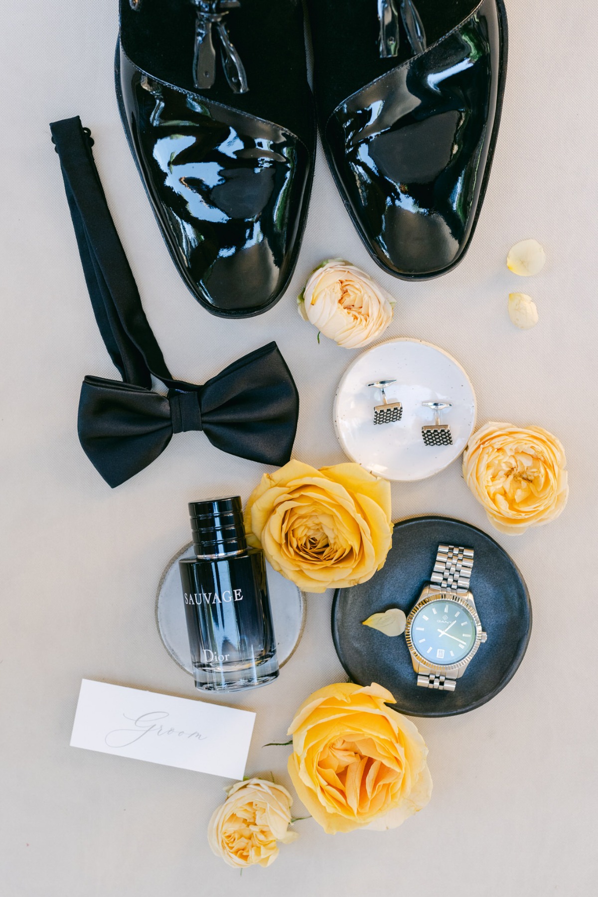 Modern yet timeless groom accessories and shiny shoes 