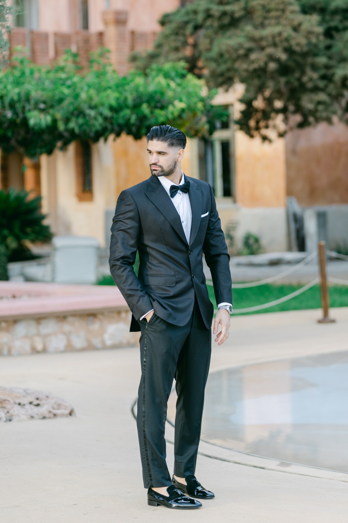 Timeless groom in classic black tuxedo with shiny loafers