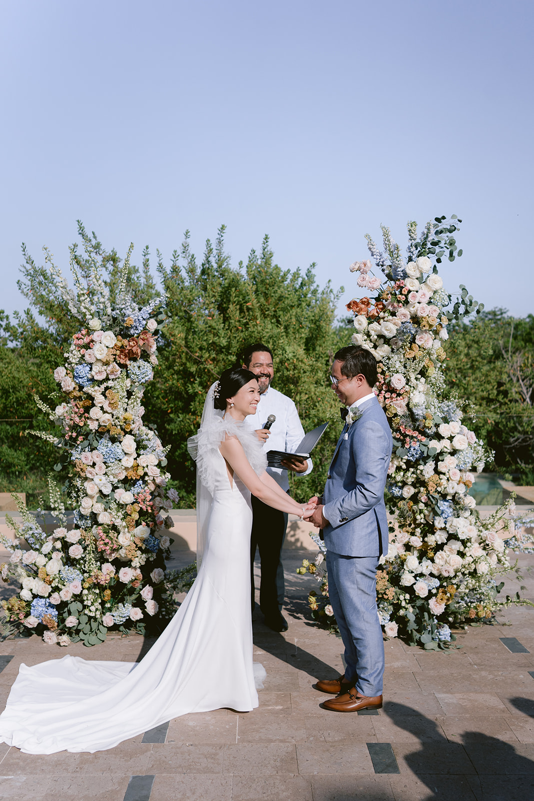 blue and peach wedding ceremony floral towers