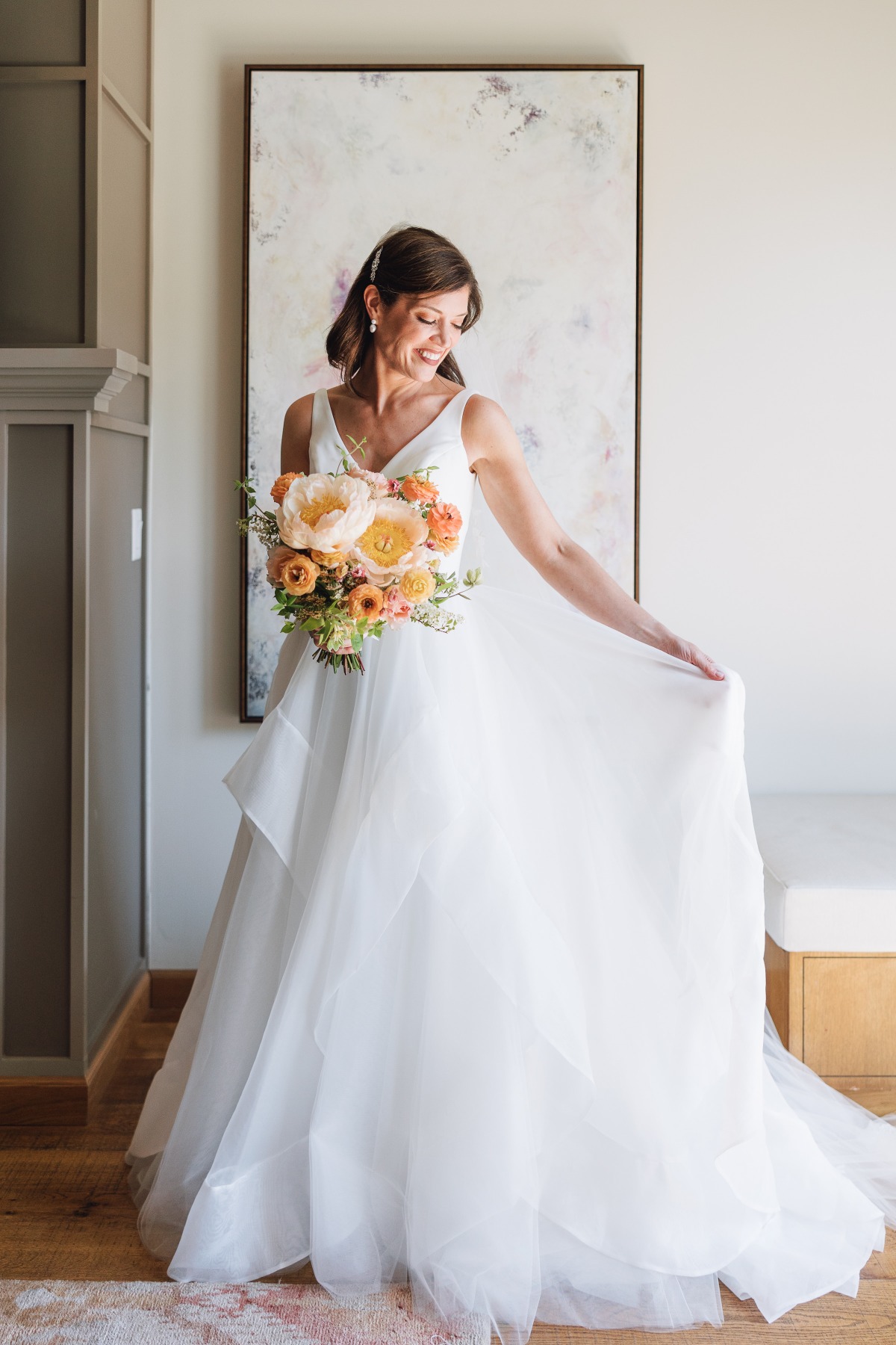 Bride in Justin Alexander wedding gown with peach bouquet 