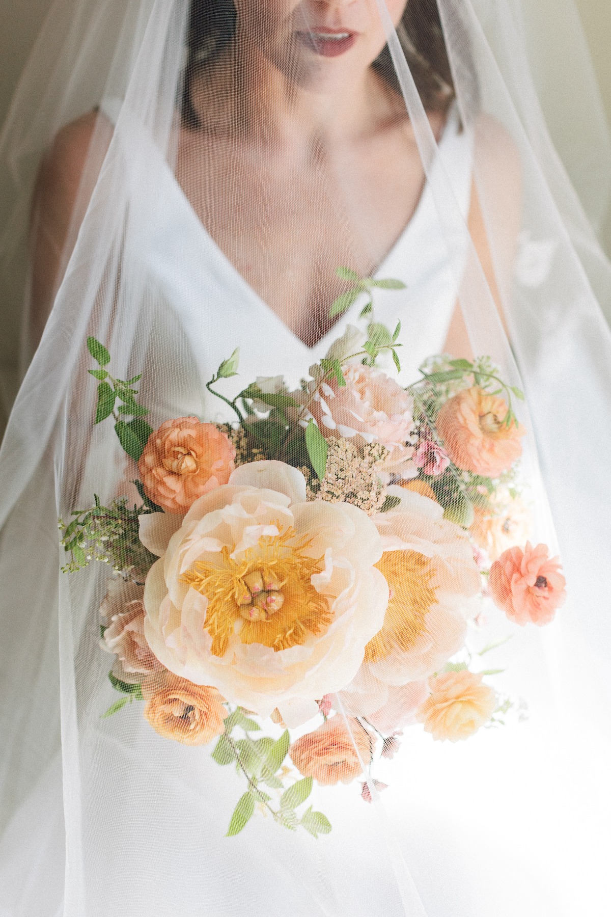 Lush blooming bridal bouquet in peach palette