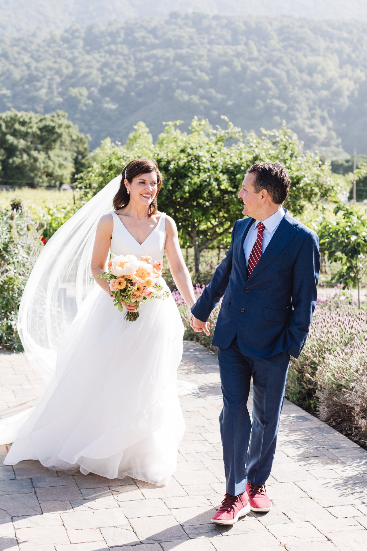 Elegant newlyweds walking at Carmel Valley garden wedding 
