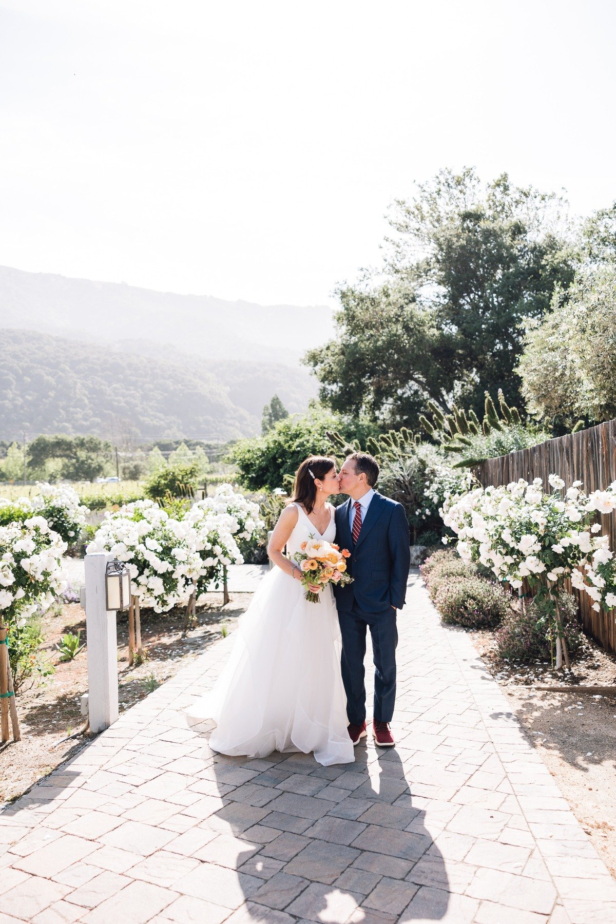 Newlyweds kiss at romantic Carmel Valley garden wedding