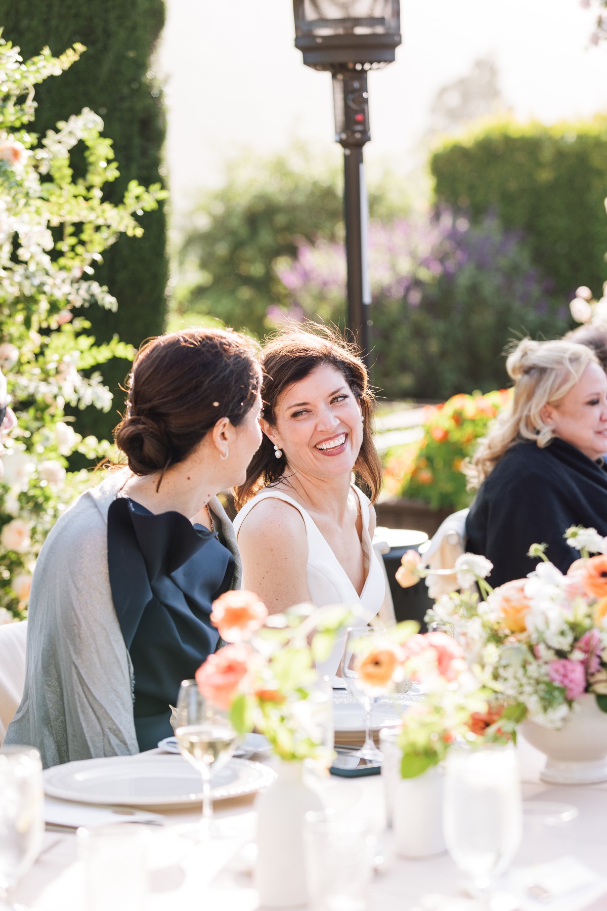 Joyful bride at vibrant garden reception in Carmel Valley