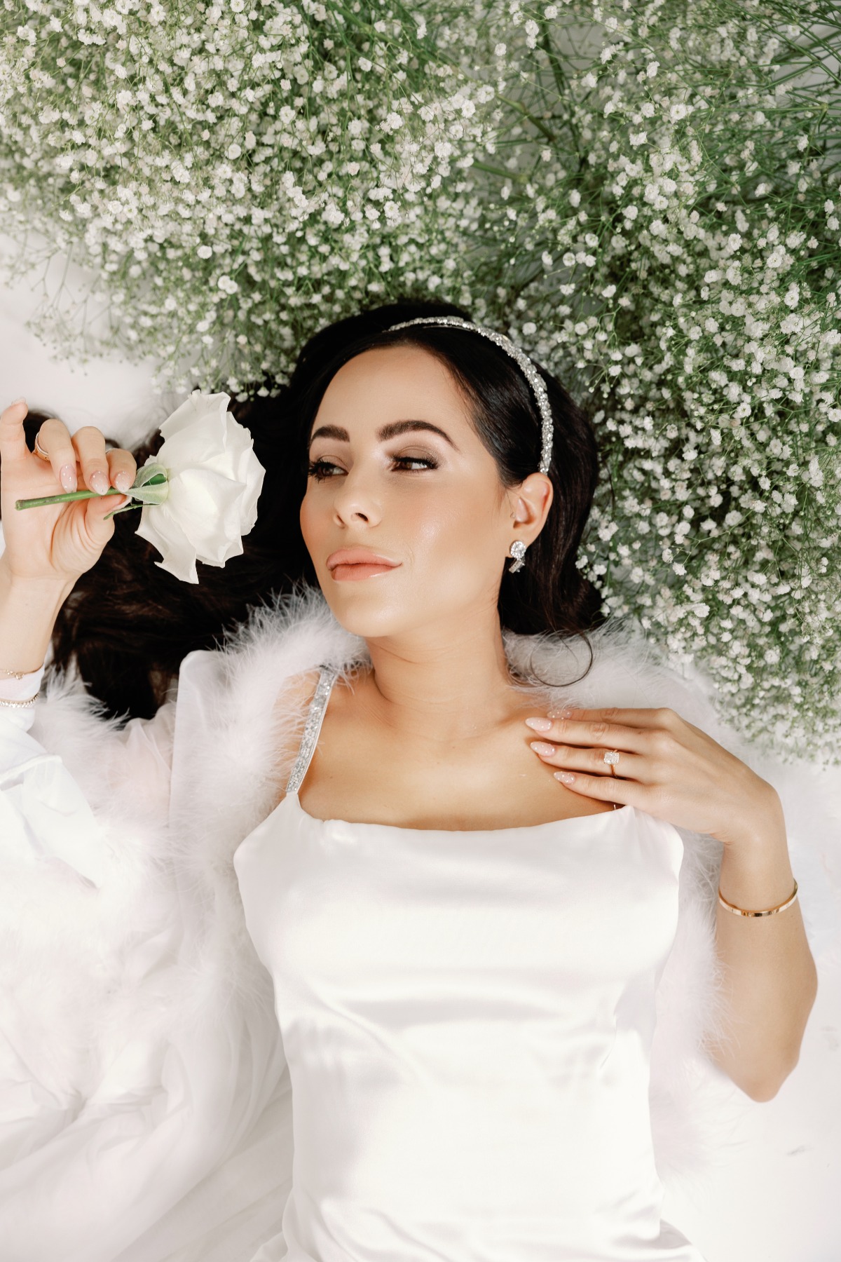 Luxury glam bride laying in baby's breath portrait 