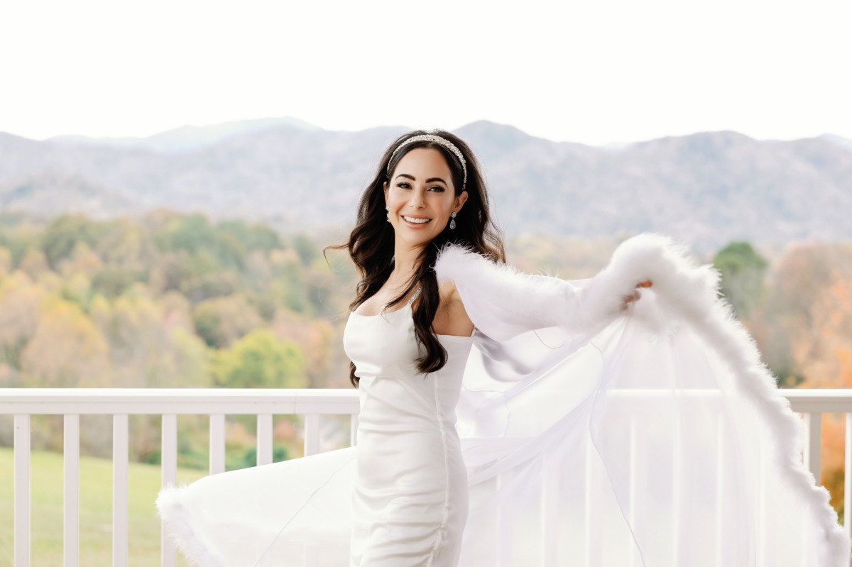 Bride twirling in luxurious feathered getting ready robe