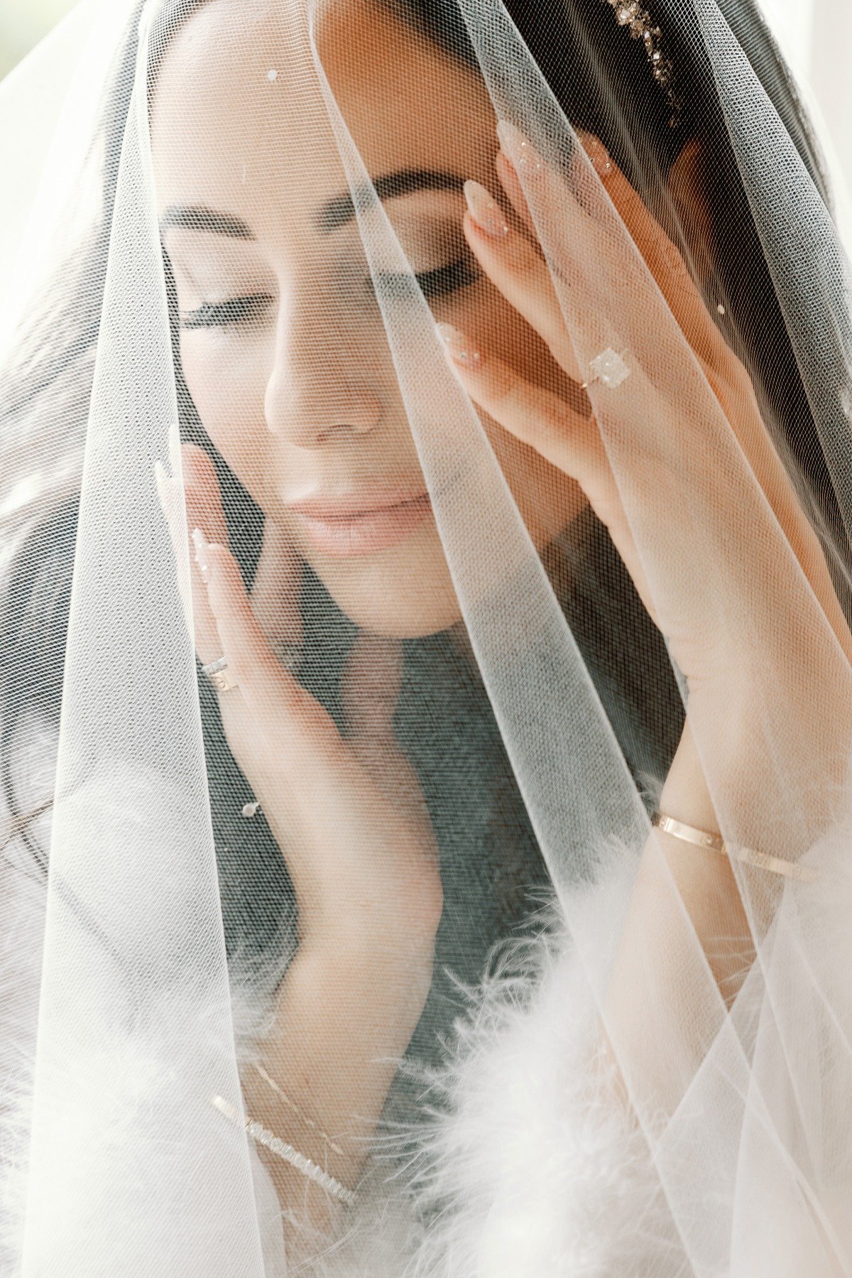 Luxury glam bride in ethereal veil, jewelry, and robe