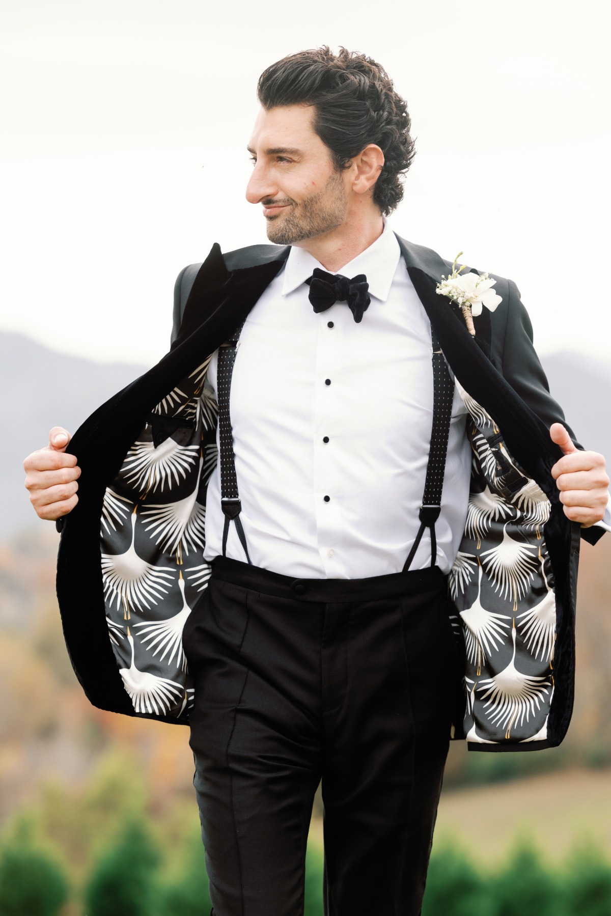 Custom lined groom suit with polkadot suspenders and bow tie