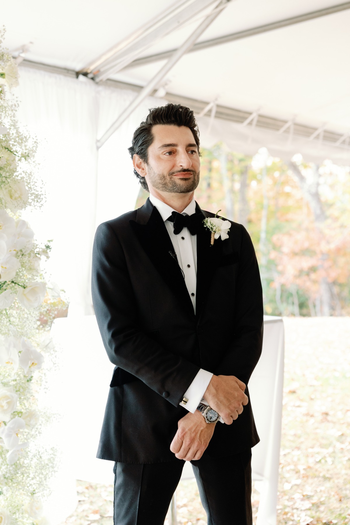 Dapper groom in custom tuxedo waiting for bride to walk aisle