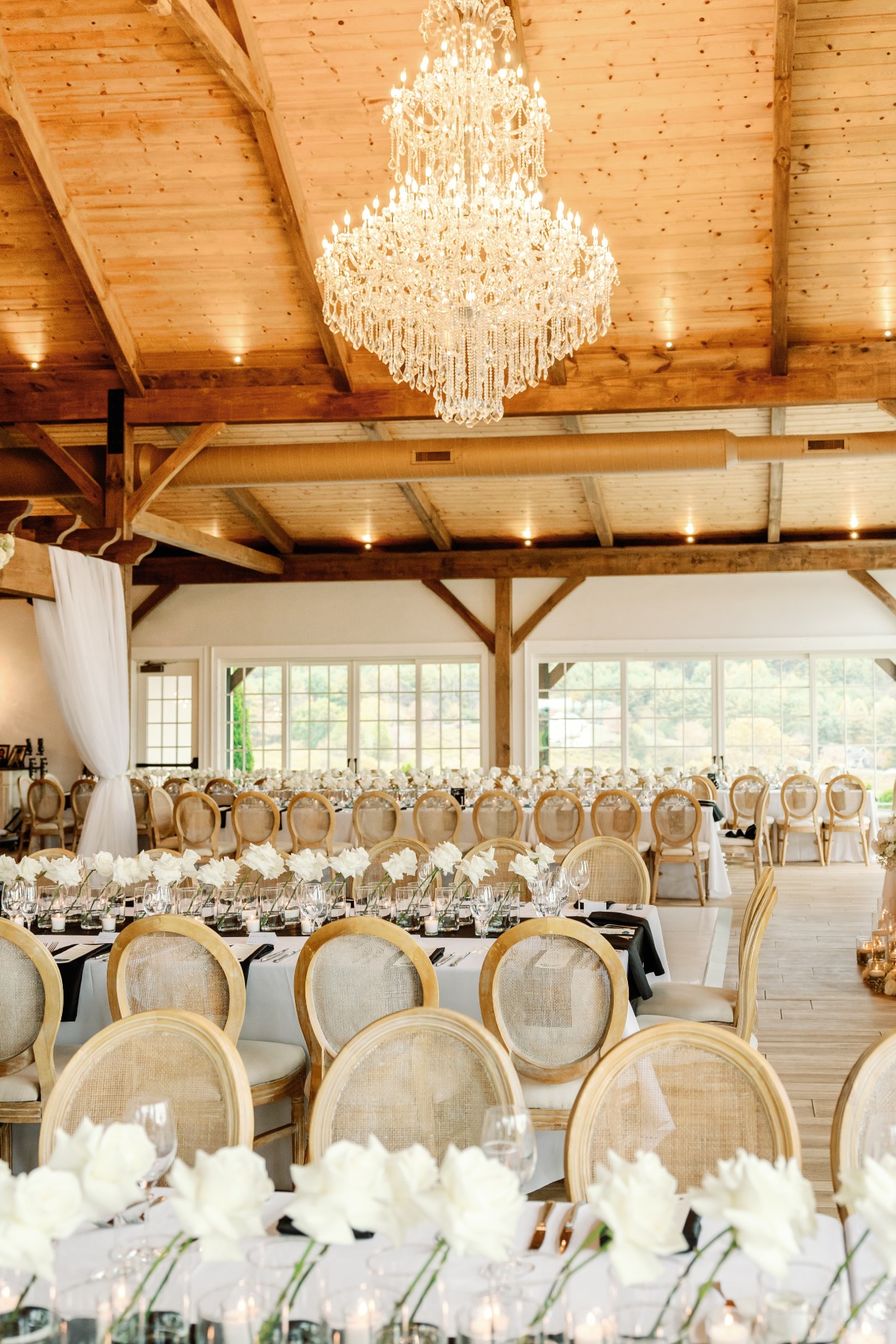 Romantic crystal chandelier filled indoor wedding reception 