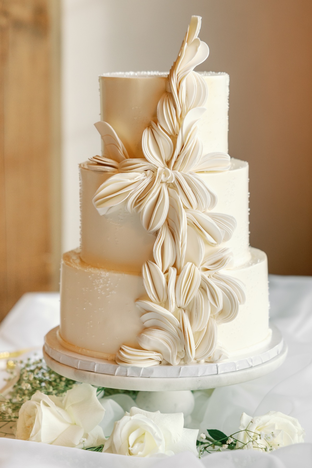 Elegant and unique textured wedding cake with layers and pearls 