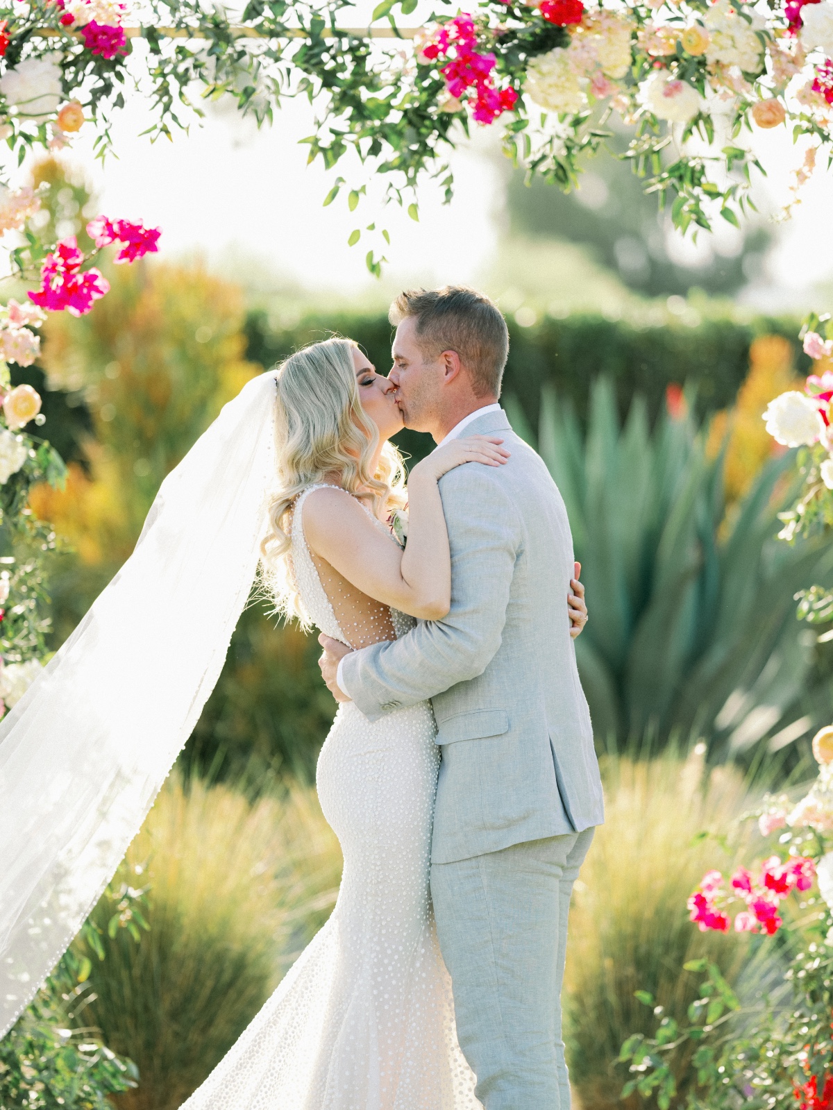 First kiss at modern Arizona desert wedding ceremony