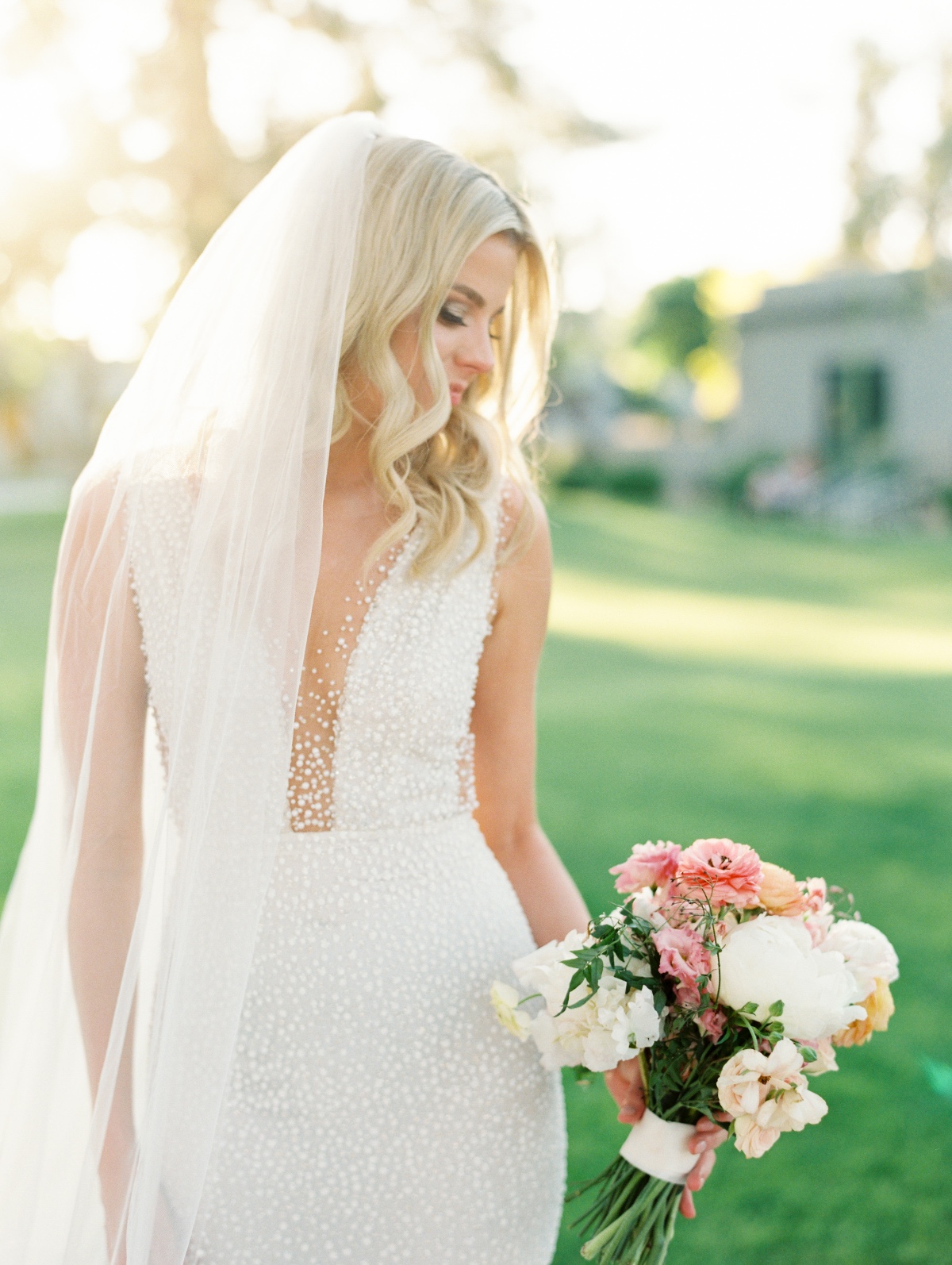 Golden hour bridal portraits of bride in pearl wedding gown